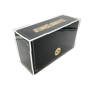 May include: A clear acrylic display box with a black base and gold accents. The box features the text "Sword & Shield" and a Pokemon logo.
