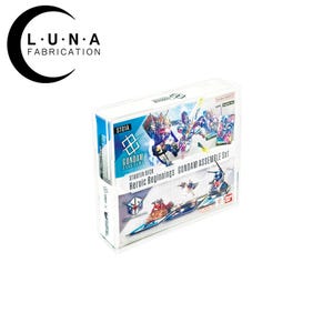May include: A white box set featuring the text "GUNDAM CARD GAME" and "Heroic Beginnings GUNDAM ASSEMBLE Set." The box has colorful illustrations of Gundam characters and logos. The Luna Fabrication logo is in the upper left corner.