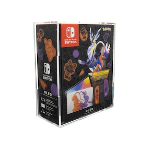 May include: A Nintendo Switch OLED console with a Pokemon Scarlet and Violet themed design. The console is in a clear plastic case with a black background and colorful graphics. The case also includes a pair of purple and orange Joy-Con controllers.