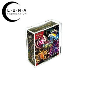 May include: A clear acrylic display case containing a Pokemon Paldean Fates Booster Bundle. The bundle features colorful graphics of Pokemon characters and the text "Paldean Fates". The case has the text "BOOSTER BUNDLE" on top.