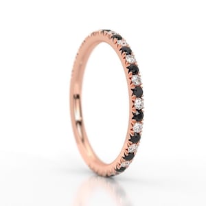 K&ouml;nnte beinhalten: Ein Ros&eacute;gold-Bandring mit abwechselnd schwarzen und wei&szlig;en Diamanten.