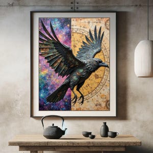 May include: Framed artwork featuring a raven in flight. The raven is depicted with detailed feathers and a dark color palette. The background is split, with a starry galaxy on the left and a vintage map on the right. The artwork is displayed on a wooden table.