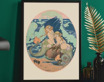 May include: A framed illustration of two mermaids with flowing hair and tails, sitting on a rock in the ocean. The ocean is depicted with blue and green waves and bubbles. The illustration is set against a white background.