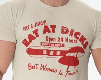 May include: A man wearing a beige t-shirt with a red graphic that says "Eat at Dicks" and "Best Weenie in Town!" The graphic also includes a hot dog and a red and white striped umbrella.
