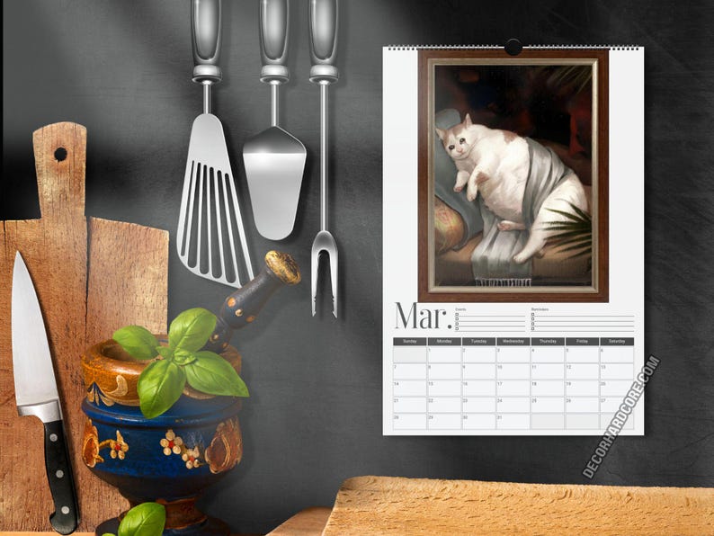 May include: A wall calendar for the month of March featuring a framed illustration of a white and brown cat resting on a sofa. The calendar includes a grid for dates and the text Mar. at the top. The design is displayed against a dark background.