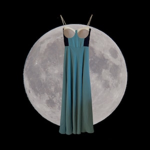 May include: A long, flowing, teal blue dress with a white and black bodice. The dress is hanging in front of a full moon.