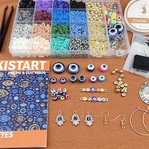 May include: A craft kit for making jewelry with evil eye beads. The kit includes a variety of blue, green, and multi-colored evil eye beads, gold beads, and silver charms. The kit also includes a booklet with instructions and ideas for making jewelry.