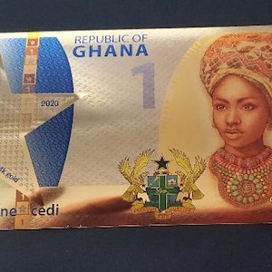 May include: A gold-colored Ghanaian 1 cedi banknote featuring a portrait of a woman wearing a head wrap and a necklace. The note also features the text "REPUBLIC OF GHANA" and "one cedi".