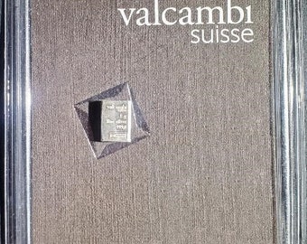 Può includere: Una barra d'argento in una custodia di plastica trasparente con il testo "Valcambi Suisse" sulla custodia.