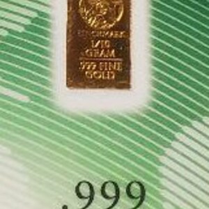 Puede incluir: Una barra de oro con la inscripci&oacute;n "1/10 OUNCE .999 FINE GOLD" y un dise&ntilde;o de &aacute;rbol estilizado.