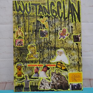 May include: A mixed media artwork featuring the words "WUTANG CLAN" in black outlined in yellow. The background is yellow with black paint drips. Various images of people and album covers are collaged onto the artwork.