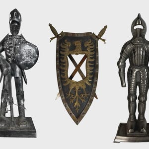 May include: Three decorative metal knight figurines and a shield. The knight on the left is holding a shield with a cross design. The shield in the center has a gold eagle design and two swords. The knight on the right is standing at attention.