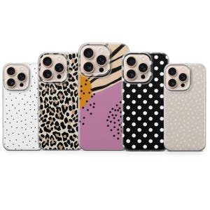 May include: Five phone cases with different patterns. The cases feature a white case with black polka dots, a leopard print design, an abstract design, a black case with white polka dots, and a beige case with small dots.