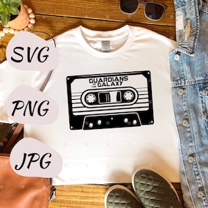 May include: White t-shirt with a black and white cassette tape graphic that says "Guardians of the Galaxy".