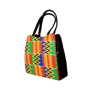 May include: A black and green tote bag with a colorful geometric pattern. The pattern features yellow, red, blue, and black stripes and zigzags.