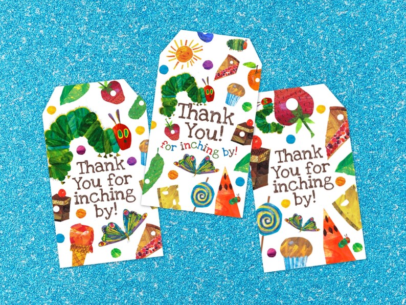 May include: Three colorful gift tags featuring the Very Hungry Caterpillar. Each tag has a white background with a green caterpillar, red apple, and various other colorful foods. The text on the tags reads "Thank You! for inching by!"