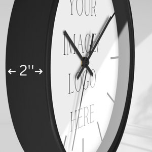May include: A black and white clock with a 2-inch diameter. The clock face has the text "YOUR IMAGE LOGO HERE".