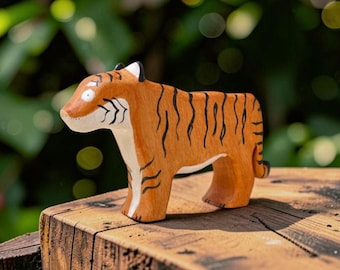 May include: A hand-carved wooden tiger figurine featuring a warm orange-brown finish with painted black stripes, a white underbelly, and a white face with black markings. The tiger is depicted in a standing profile position with a simple design.