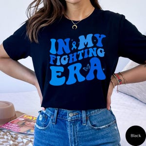 Camiseta de concientización sobre el cáncer de colon, camisetas con gráficos de lazos contra el cáncer, camisetas de apoyo contra el cáncer, regalo para sobrevivientes de cáncer de próstata, más fuerte que el cáncer, N015