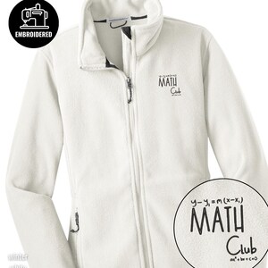 May include: White fleece jacket with a full zipper and a stand-up collar. The jacket has the words "MATH Club" embroidered on the chest, along with mathematical equations. The jacket also has the word "EMBROIDERED" in a circle.