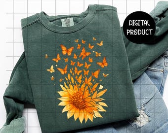 May include: A dark green sweatshirt featuring a sunflower design with orange butterflies. The sunflower is in full bloom with detailed petals. The text "PNG 300 DPI - HIGH RESOLUTION" and "READY TO PRINT - PNG SUBLIMATION FILE" are visible.
