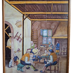 May include: A framed artwork composed of ceramic tiles, depicting a tavern scene. The artwork features figures in period clothing, seated around tables. The scene is set in a rustic interior with a wooden ceiling and walls. The artwork is framed in a dark wood.