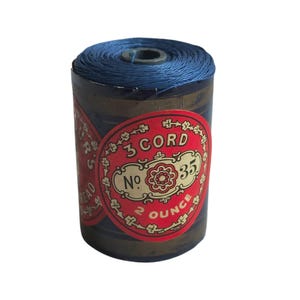 May include: A vintage spool of blue thread. The label reads "3 Cord" and "No. 35", with a red and gold design. The spool contains 56.7 grams of thread.