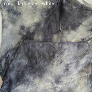 May include: Close-up of a dark gray and white fabric with a tie-dye pattern. The fabric is soft and textured, with a subtle sheen.