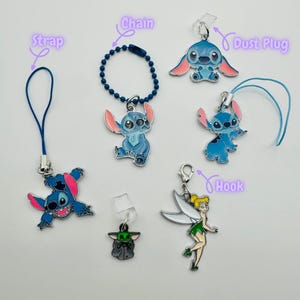 May include: A set of eight charms featuring Stitch and Tinkerbell. The charms are made of metal and have a blue, green, and white color scheme. The charms are attached to different types of chains, straps, and hooks. The charms are perfect for adding a touch of Disney magic to your bag, keychain, or phone.