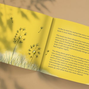 May include: Open book with yellow pages and text about grief. The book has dandelion illustrations on the cover and inside pages.