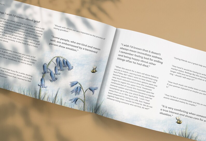 May include: An open book with bluebells and a bee on the cover. The text on the page reads "I wish I'd known that it doesn't always mean immediate sadness. I remember feeling bad for smiling and being happy about other things after he had died."