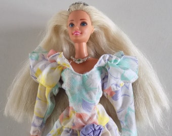 Vintage Barbie doll from 1990/2000, multicolored floral mid-length dress.