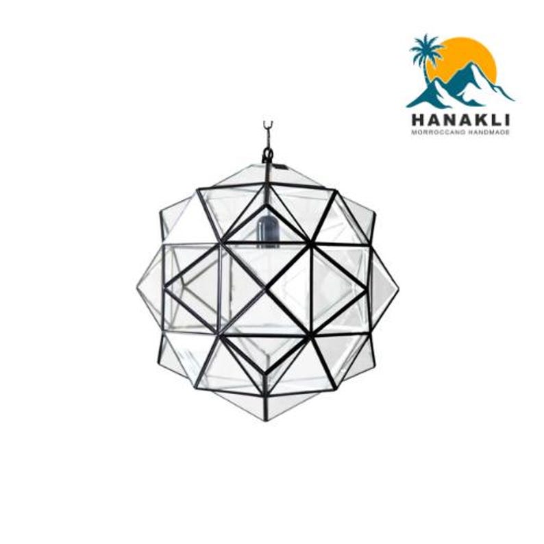 May include: A geometric glass pendant light with a black metal frame. The light fixture is made of clear glass and has a modern design.