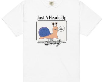 May include: White t-shirt with a graphic of a snail with a speech bubble that says "I'm Tired!" and the text "Just A Heads Up I'm Moving Slowly Today".