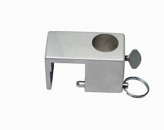 May include: Silver metal clamp with a round hole and a small screw. The clamp has a small ring attached to it.