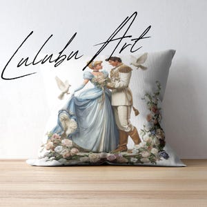 May include: A decorative pillow featuring a romantic illustration of a couple in formal attire, surrounded by flowers and doves. The couple is dressed in blue and white, with the text "Luluba Art" in a script font.