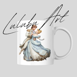 May include: White ceramic mug featuring a romantic illustration of a couple dancing in a ballroom. The couple is dressed in elegant attire, with the woman in a blue gown. The mug has the text "Lulubu Art" in a script font.