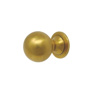 May include: A round, gold-toned cabinet knob with a smooth, slightly textured surface. The knob has a circular base with a raised edge.
