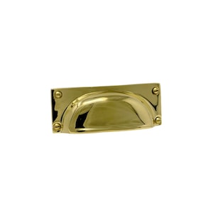 May include: A polished brass cabinet pull with a rounded rectangular shape and a curved, recessed center. The pull has four small, round, decorative knobs.
