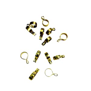 May include: A group of ten gold-colored metal jewelry clasps, scattered on a white background.