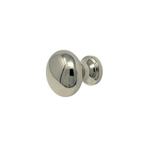 May include: A polished chrome door knob with a round, spherical design. The knob has a smooth, reflective surface.