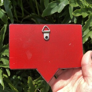 May include: Red wooden speech bubble with a metal hanging hook on the back.