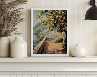 May include: A framed art print depicting a coastal Italian landscape. The artwork features a stone pathway, a tree laden with oranges, and a view of a town nestled on a hillside overlooking the sea. The color palette includes blues, greens, and yellows.