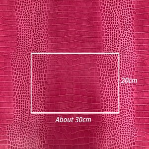 May include: Close-up of a pink crocodile-embossed fabric with a rectangular section highlighted. The fabric measures approximately 30cm by 20cm.