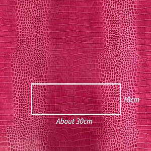 May include: Pink faux crocodile embossed fabric with a textured pattern. The fabric is approximately 30 inches wide and 10 inches tall.