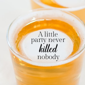 May include: A glass of beer with a white head and the text "A little party never killed nobody" on the foam.