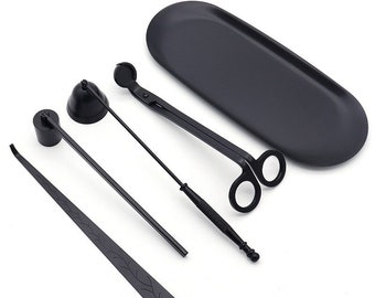 May include: A set of black candle care tools including a snuffer, a wick trimmer, a pair of candle scissors, and a tray.