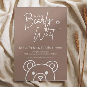 Puede incluir: Invitaci&oacute;n a un baby shower con fondo marr&oacute;n y texto blanco. El texto dice "Bearly Wait" e incluye detalles para el baby shower de Jessica el 25 de abril. Una ilustraci&oacute;n de oso de peluche est&aacute; en la parte inferior.