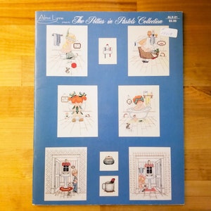 May include: A cross-stitch pattern booklet titled "The Potties in Pastels Collection" by Alma Lynne. The booklet features six different cross-stitch patterns of children in various bathroom settings.