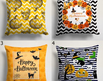 May include: Four Halloween-themed throw pillows. The first pillow has a yellow chevron pattern with pumpkins and skulls. The second has a black and white chevron pattern with pumpkins and the text "Happy Halloween". The third has an orange background with bats and the text "Happy Halloween". The fourth has a striped background with Halloween graphics.